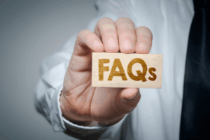 Doctor holding a tag showing Hernia Frequently Asked Questions