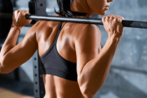 strong woman holding barbell on her shoulders (Fat Loss and Muscle Gain)